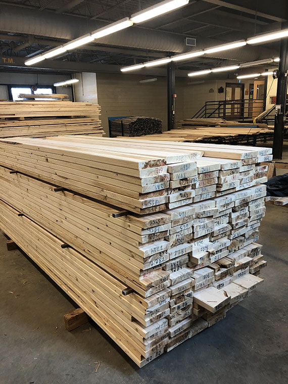 Bundles of wood planks stacked on top of one another.